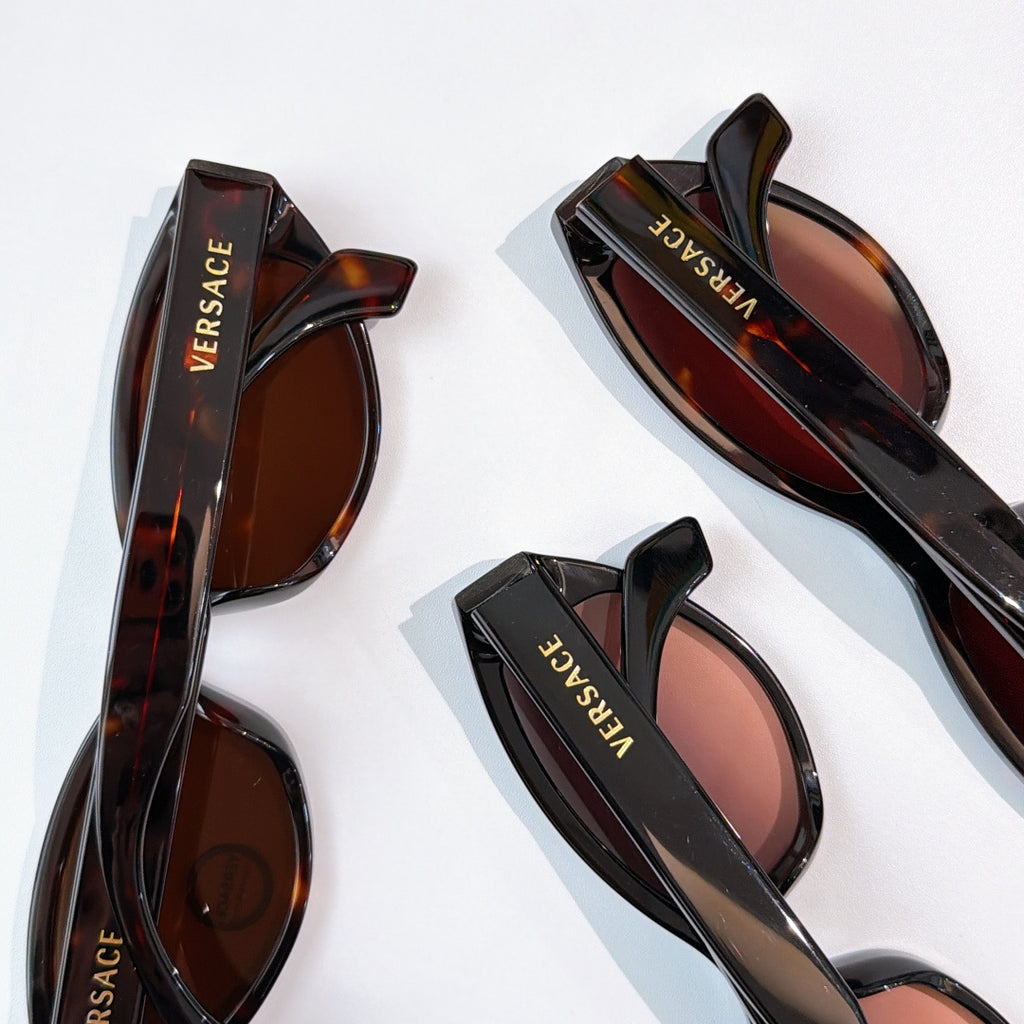 Assorted sunglasses with brown lenses, tortoiseshell and black frames, VERSACE branding