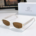 White cat-eye sunglasses with brown lenses and gold emblem temple details