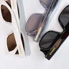 Sunglasses close-up: white frame and black frame with tinted lenses