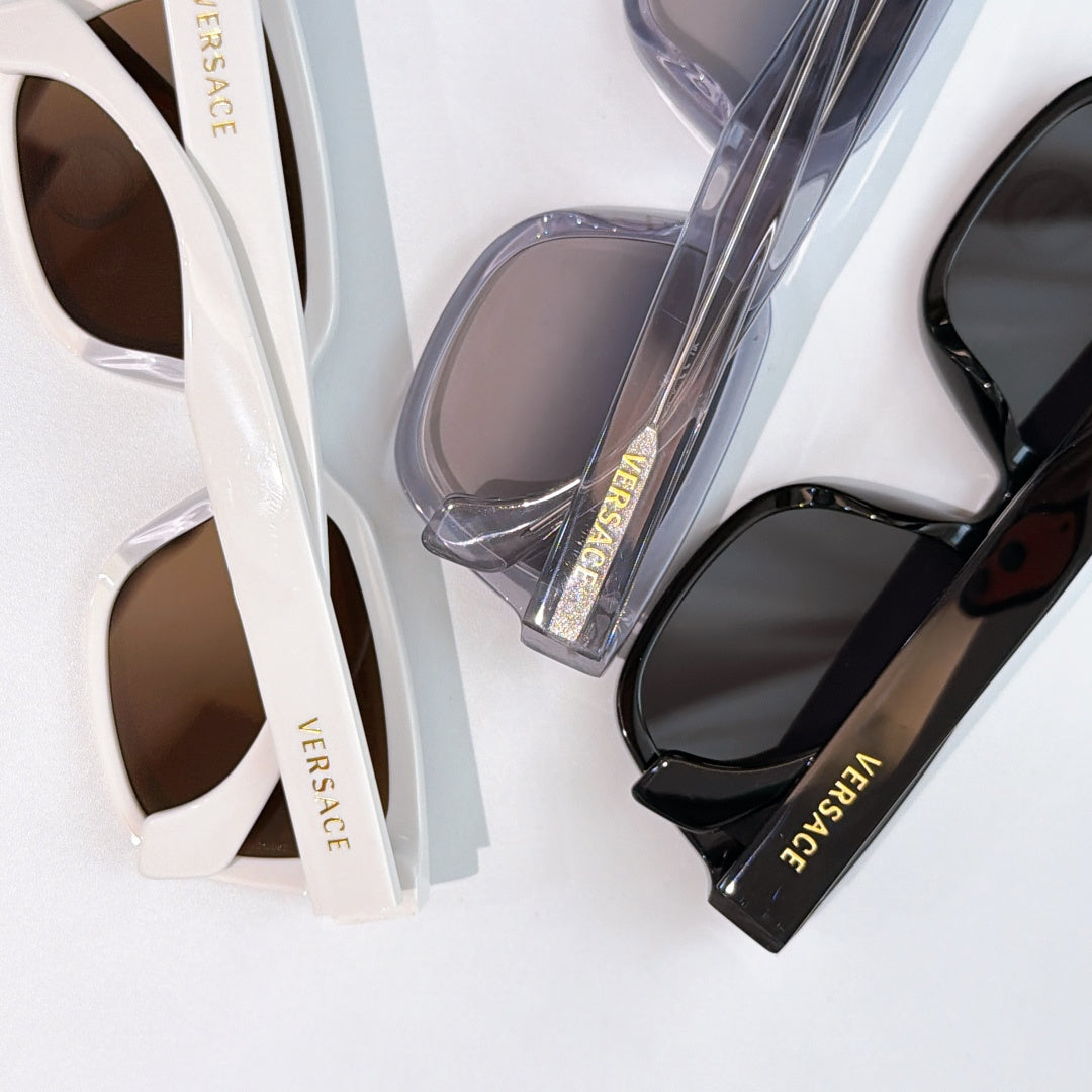 Sunglasses close-up: white frame and black frame with tinted lenses