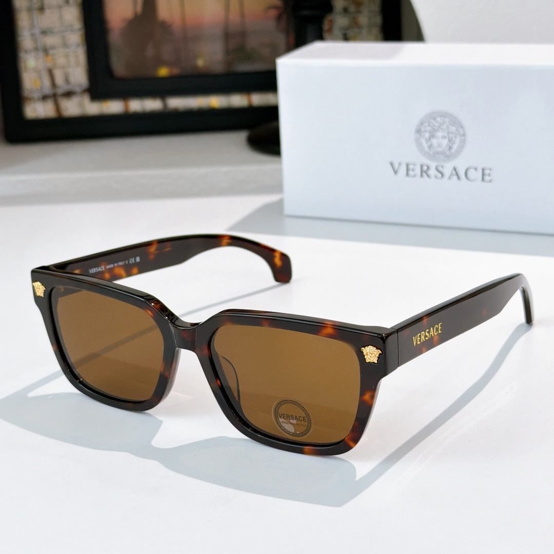Tortoiseshell cat-eye sunglasses with amber-brown lenses and gold logo accents