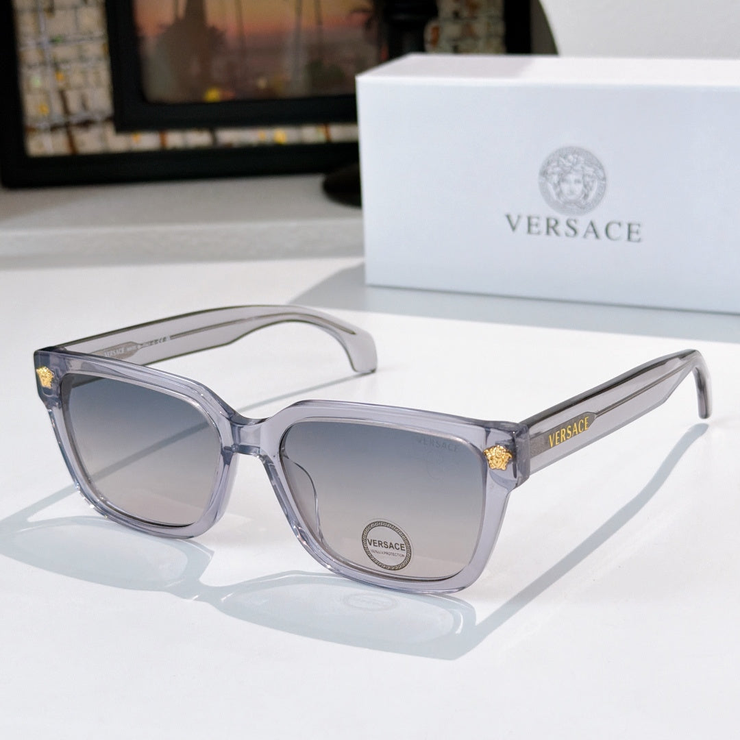 Clear/gray cat-eye sunglasses with gray lenses and gold logo accents