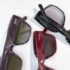 Assorted Dior sunglasses with dark, red, and plum frames