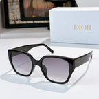 Dior sunglasses with black frames and purple-tinted lenses