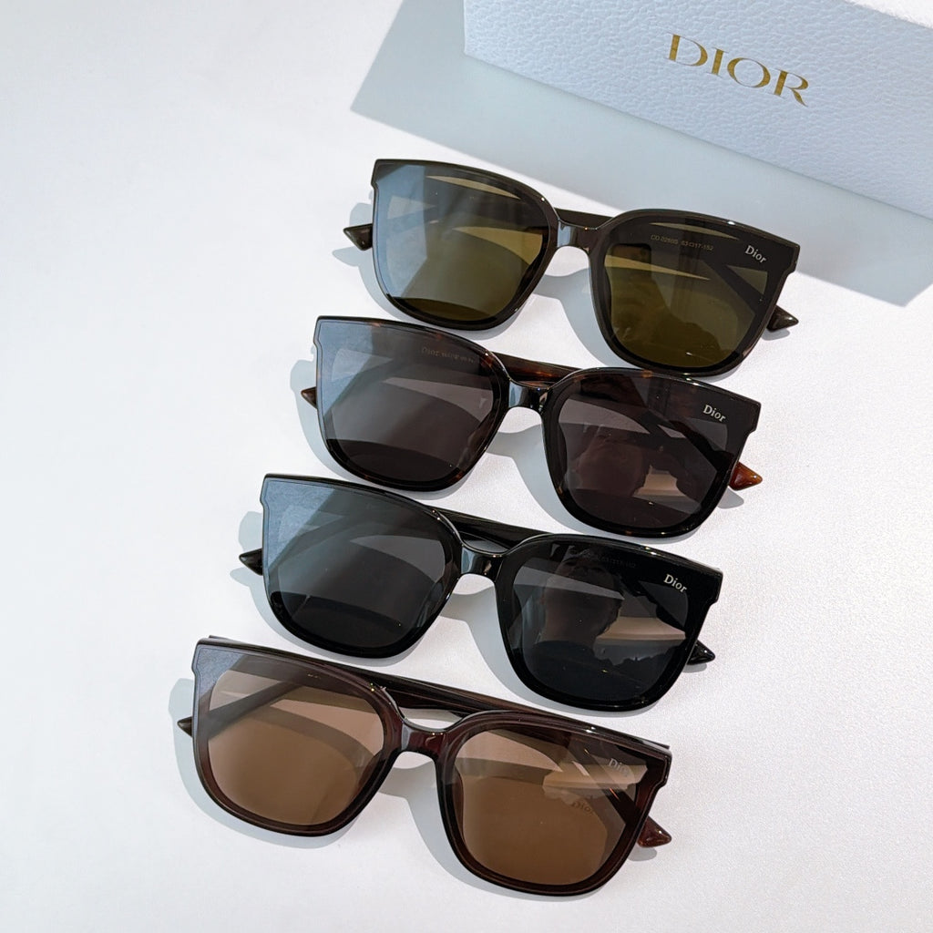 Stack of sunglasses with several frame colors and tinted lenses