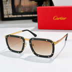 Gold-and-black sunglasses with tan lenses, rectangular frames and rivet studs.