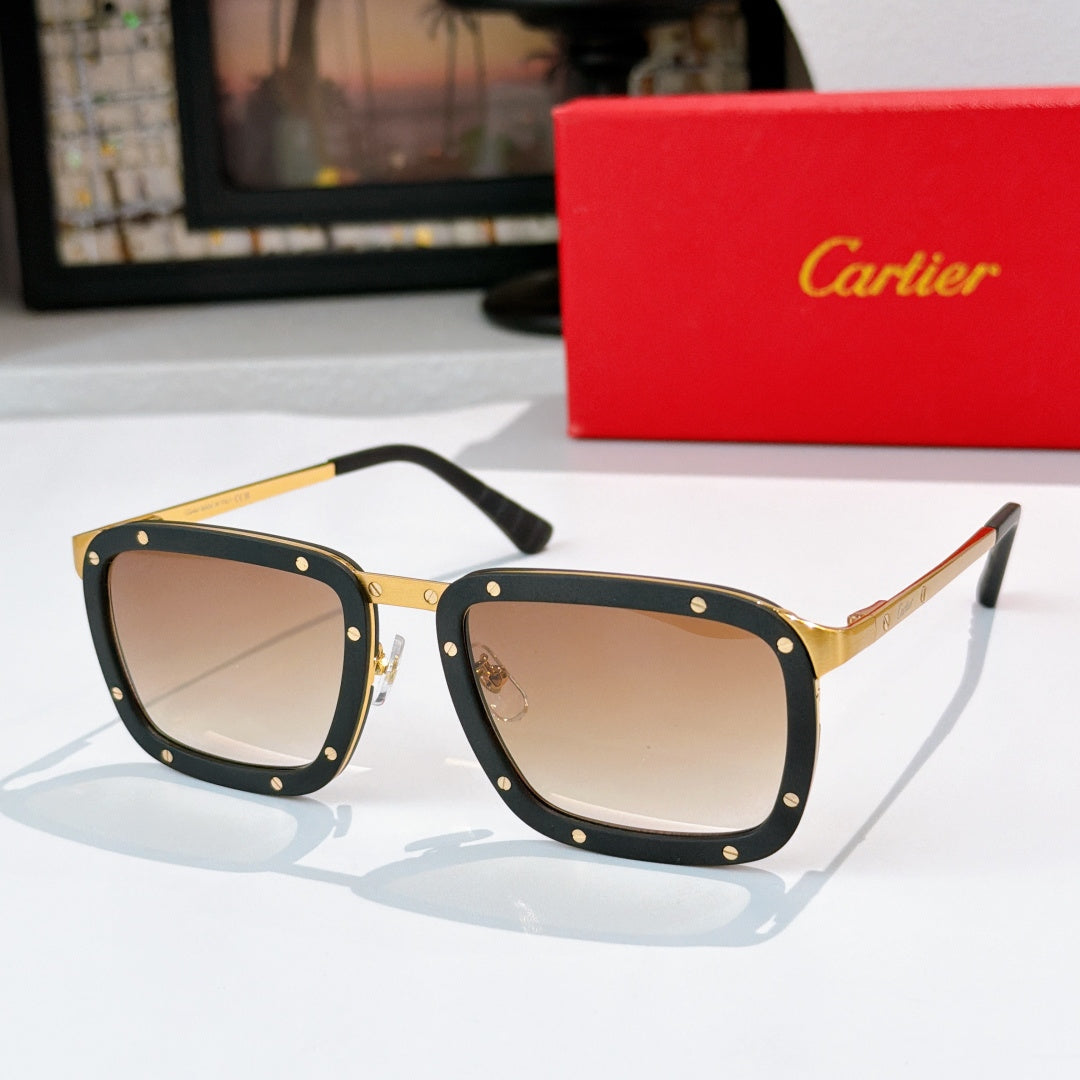 Gold-and-black sunglasses with tan lenses, rectangular frames and rivet studs.