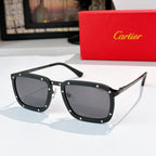 Black sunglasses with dark gray lenses, rectangular frames with stud accents.