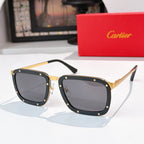 Black-and-gold sunglasses with dark gray rectangular lenses and stud detailing.