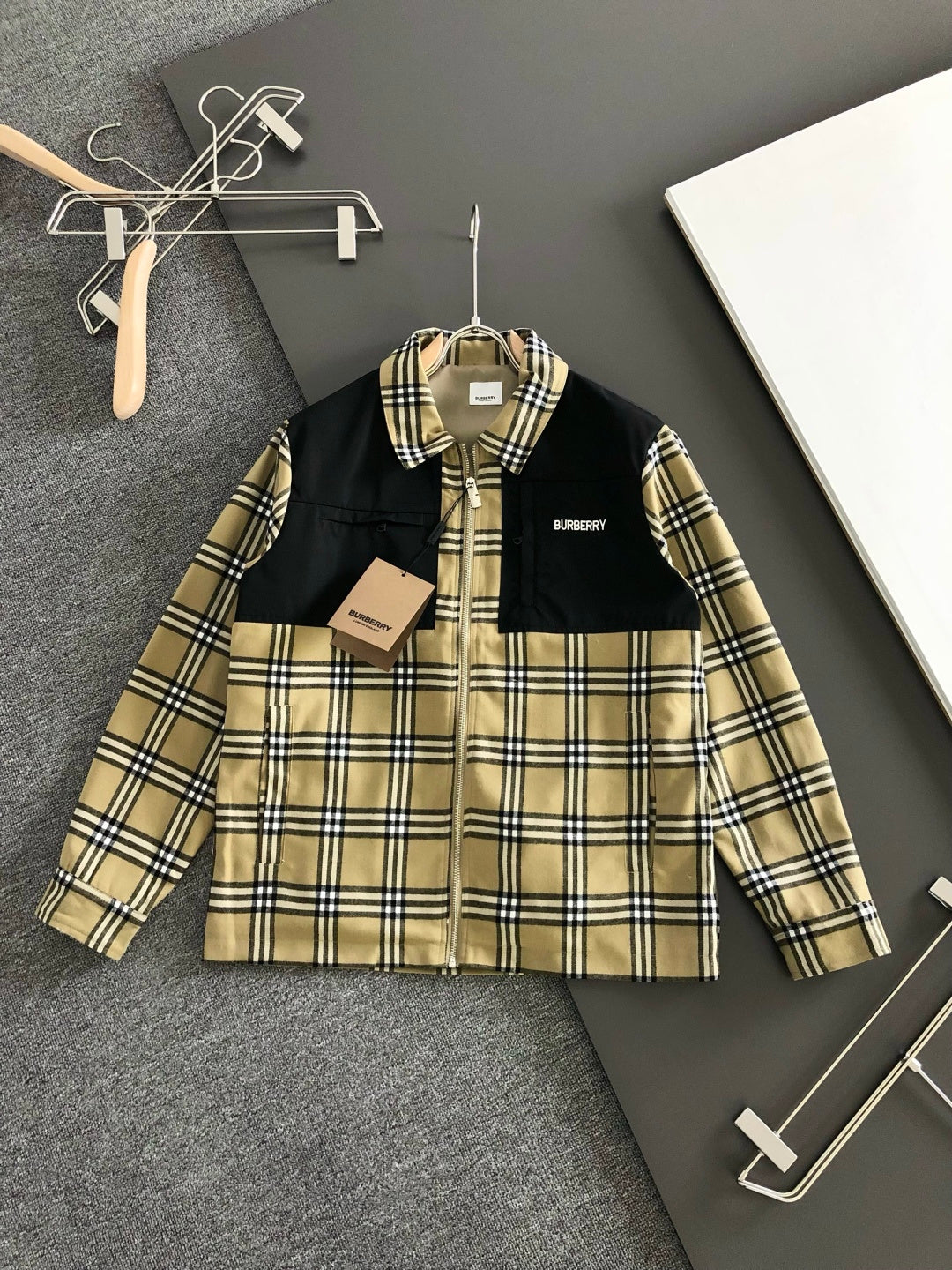 Long-sleeve jacket with black and beige plaid yoke, full-zip front, stand collar.