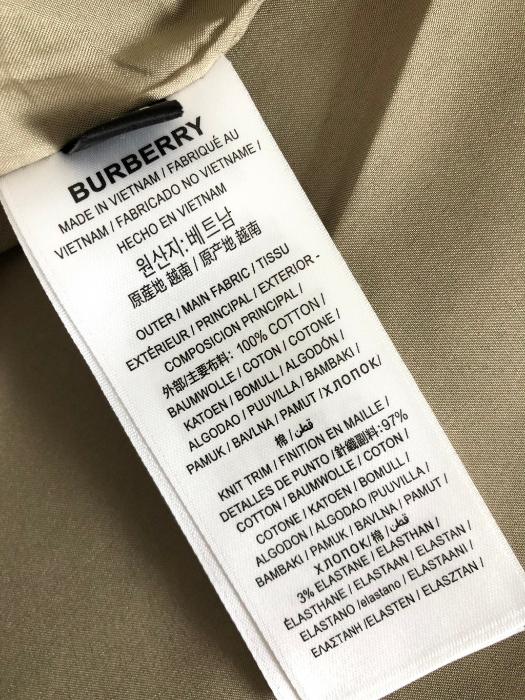Fabric care label inside a plaid jacket, with printed text and sizing details.