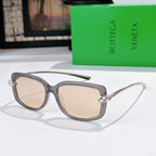 Gray translucent sunglasses with silver-tone hardware and light beige lenses.
