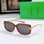 Brown tortoise sunglasses with gold-tone hardware and dark tinted lenses.