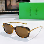 Tortoise sunglasses with gold-tone hardware and brown tinted lenses.