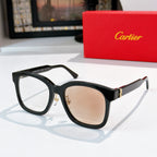 Black cat-eye sunglasses with tan lenses and gold hinges