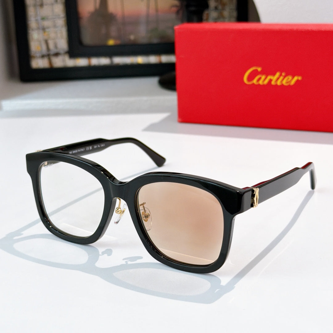 Black cat-eye sunglasses with tan lenses and gold hinges
