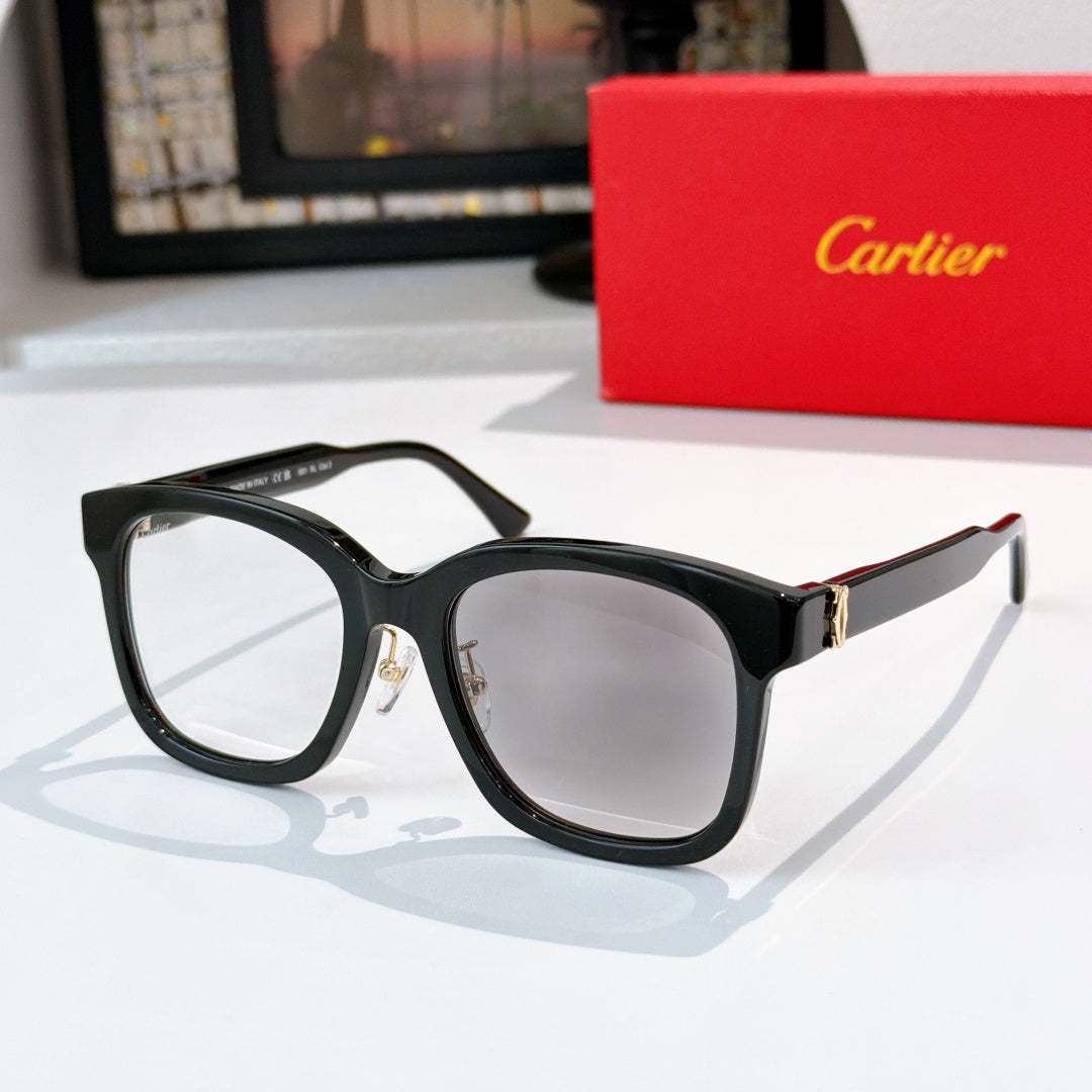 Black cat-eye sunglasses with light gray lenses and gold hinges