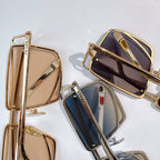 Metal sunglasses in gold, navy, and bronze with tinted lenses