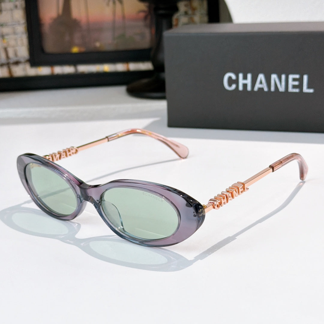 Chanel sunglasses with translucent purple frames, green tinted lenses, rose-gold chain arms.