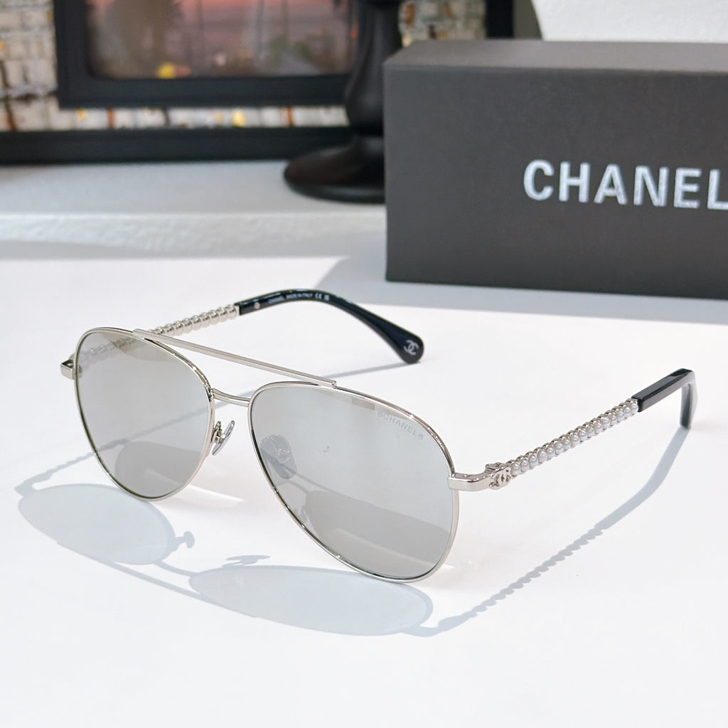 Aviator sunglasses with silver frame, mirrored gray lenses, and chain temple arms