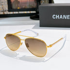 Aviator sunglasses with gold frame, amber mirrored lenses, and chain temple arms
