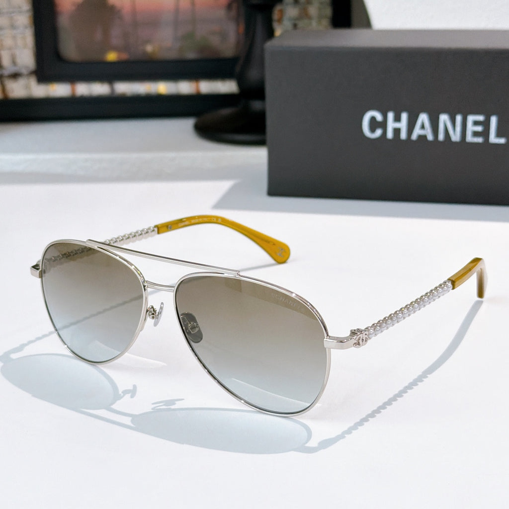 Aviator sunglasses with silver frame, mirrored gray lenses, and yellow temple accents