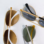 Gold-rim sunglasses with dark lenses and pearl chain strap detail
