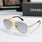 Aviator sunglasses with gold frame, blue-gray mirrored lenses, and chain temple arms