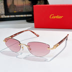Cartier sunglasses with reddish-brown frames, pink tinted lenses, and gold metal accents