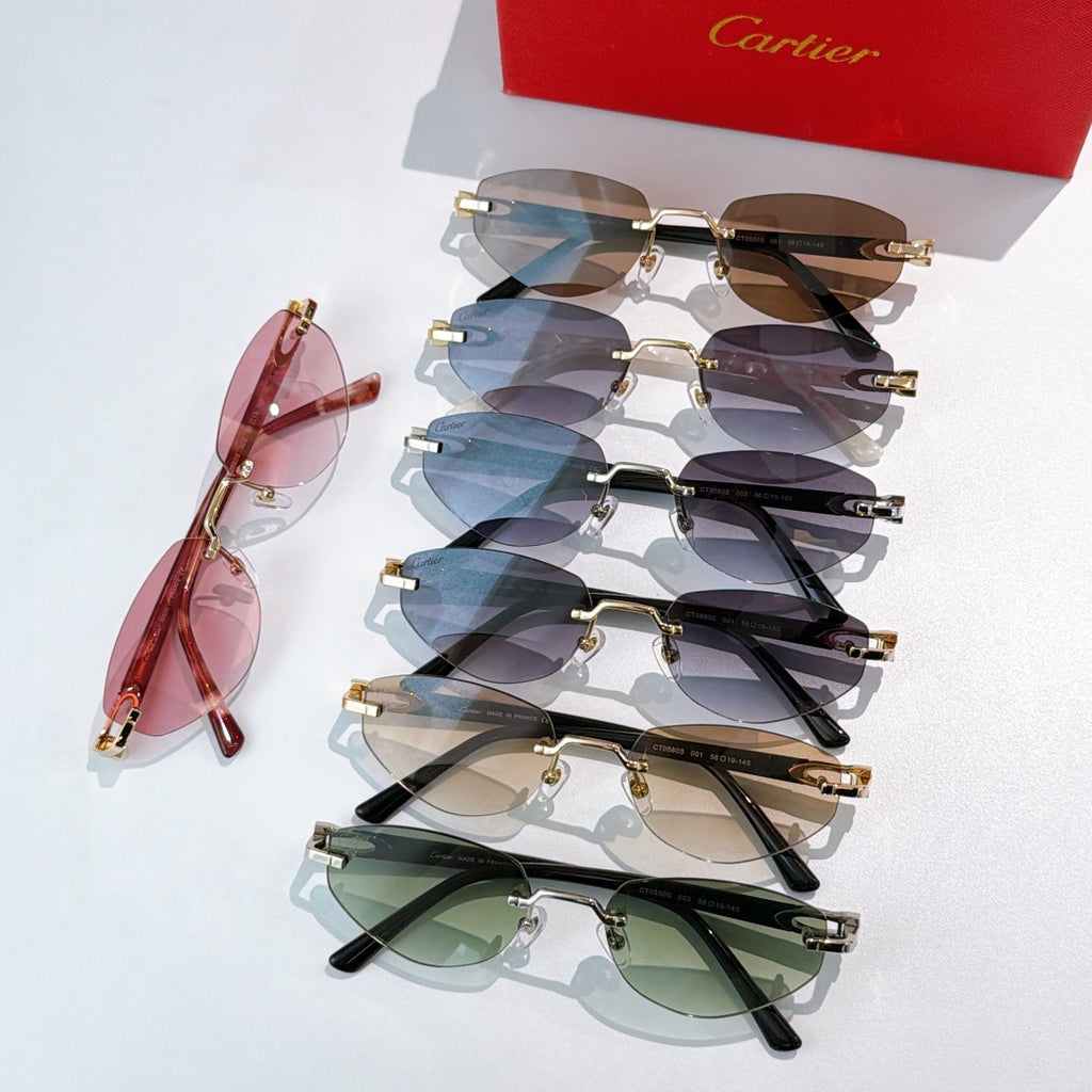 Cartier sunglasses assortment with pink, blue, green, and dark lenses, gold metal frames