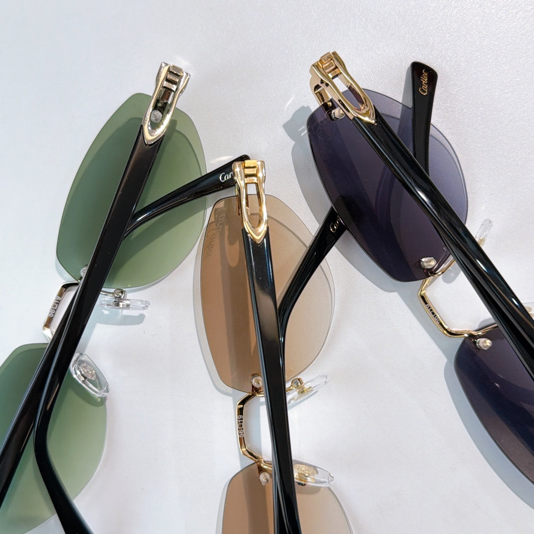 Cartier sunglasses close-up with green and dark lenses, gold metal frames