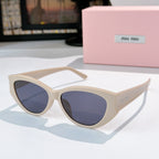 MiuMiu cat-eye sunglasses with blue-tinted lenses and cream acetate frame
