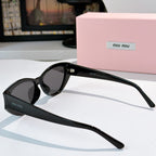 MiuMiu round sunglasses with black frame and dark gray lenses