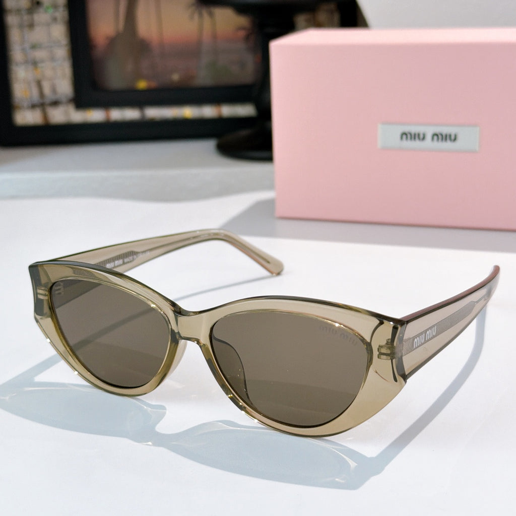 MiuMiu cat-eye sunglasses with olive-tinted lenses and gold-tone frame