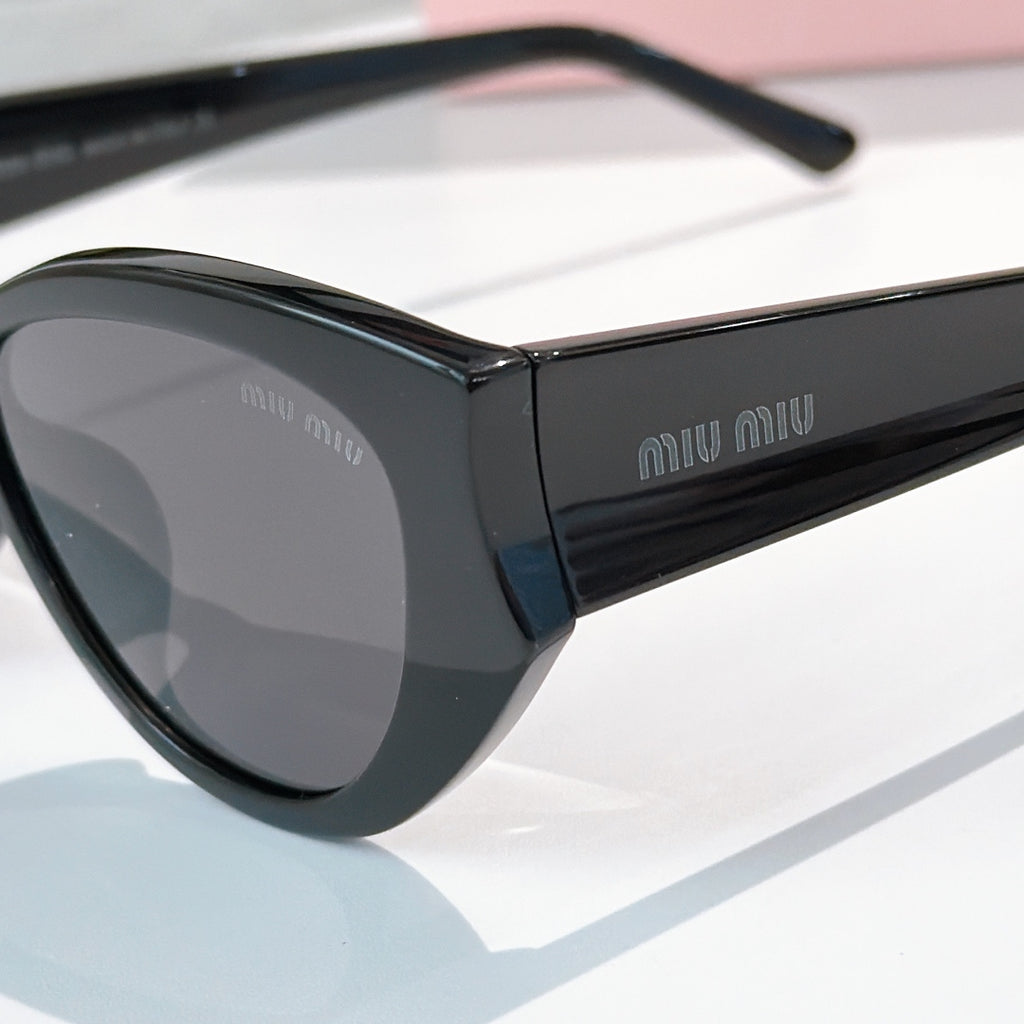 MiuMiu oversized sunglasses with black frame and gray-tinted lenses
