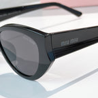 MiuMiu oversized sunglasses with black frame and gray-tinted lenses