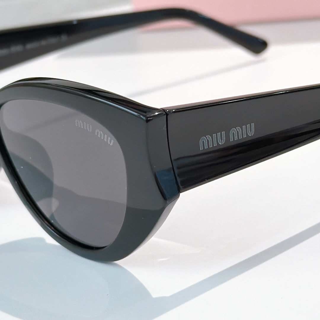 MiuMiu oversized sunglasses with black frame and gray-tinted lenses