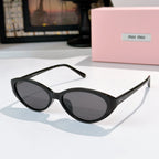 MiuMiu sunglasses with black frames and dark brown-tinted lenses