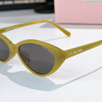 MiuMiu sunglasses close-up with yellow frames and dark tinted lenses