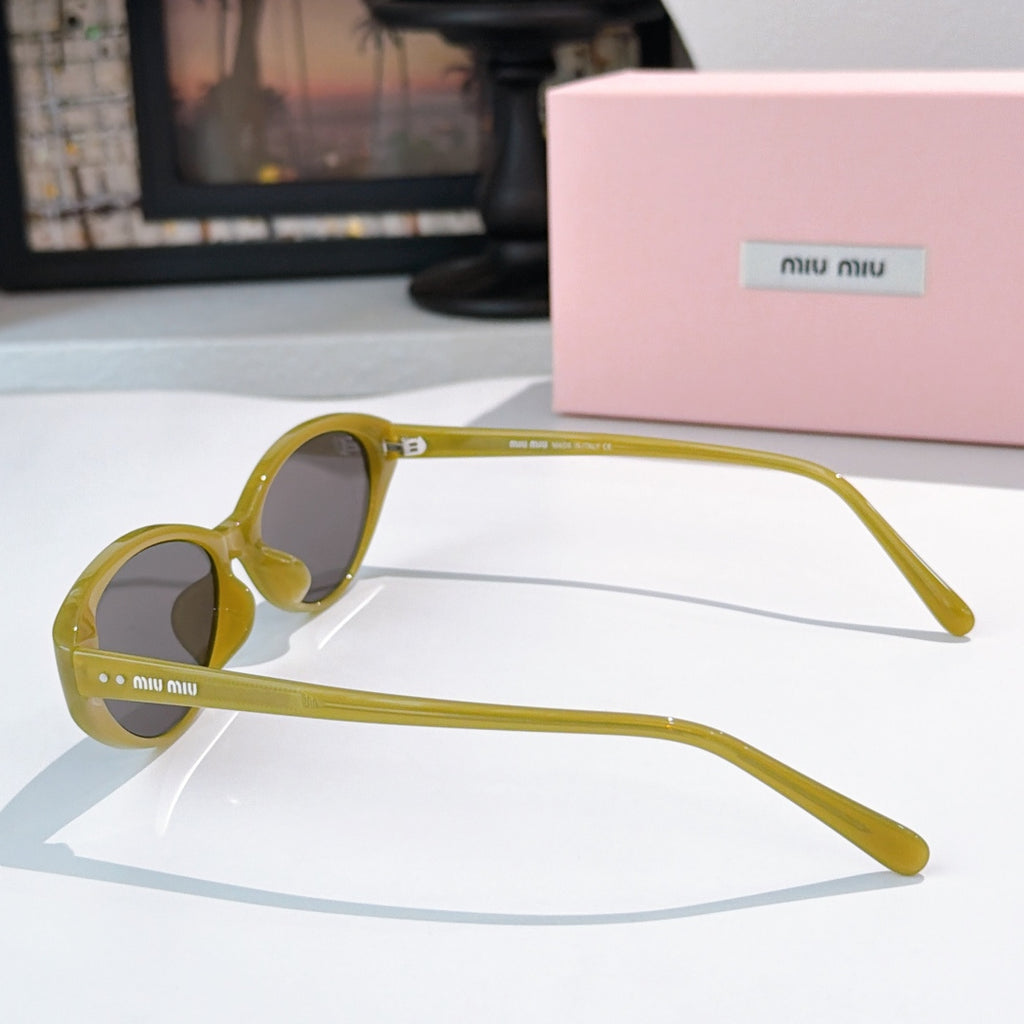 MiuMiu sunglasses side view with yellow frames and dark lenses