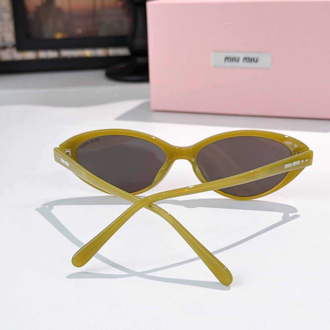 MiuMiu sunglasses front view with yellow frames and dark lenses