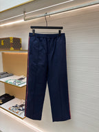 Navy pants with elastic waistband, front pleats, and side pockets