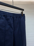 Navy pants with elastic waistband and red side stripe along the leg