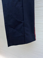 Navy straight-leg pants with tapered hem and red side stripe
