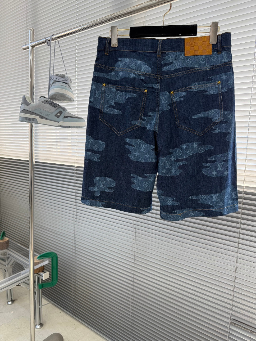 Louis Vuitton dark blue denim shorts with light blue all-over patterned print, back view