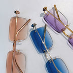 Cartier glasses assortment with purple, blue, and tan tinted lenses, gold frames