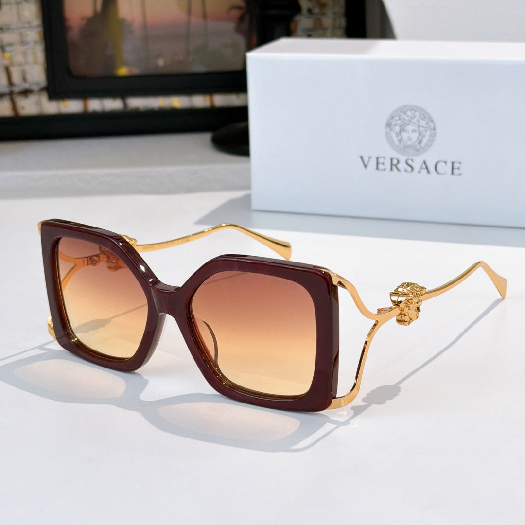 Square sunglasses with dark brown frame, gradient brown lenses, gold lion temple detail.