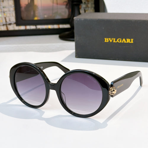 Black sunglasses with purple tinted lenses, gold BVLGARI logo on temple