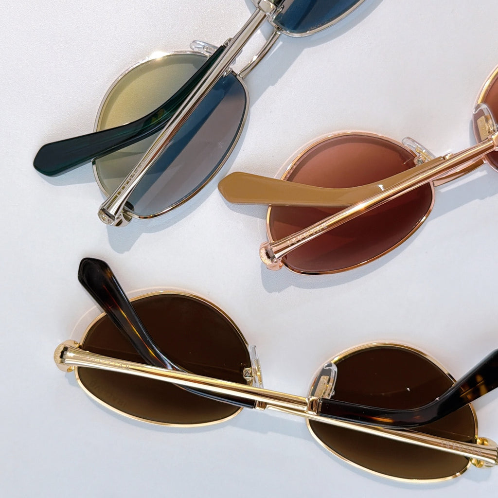 Assorted sunglasses with gold and silver frames and tinted lenses