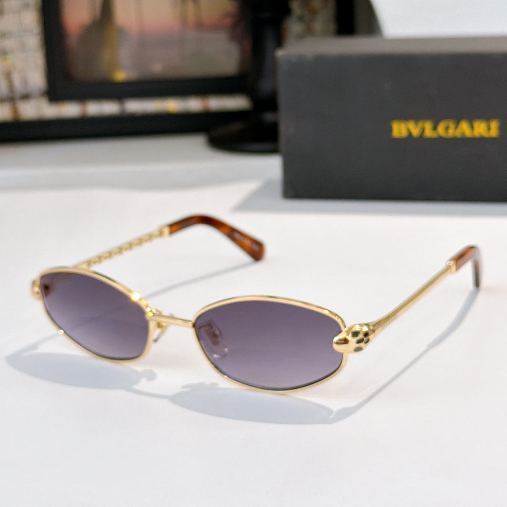Sunglasses with gold frame, tortoise accents, and light purple tinted lenses